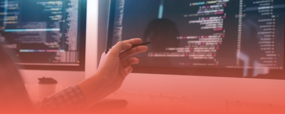 Developer working with code on multiple screens, illustrating the technical implementation of Open Mercato