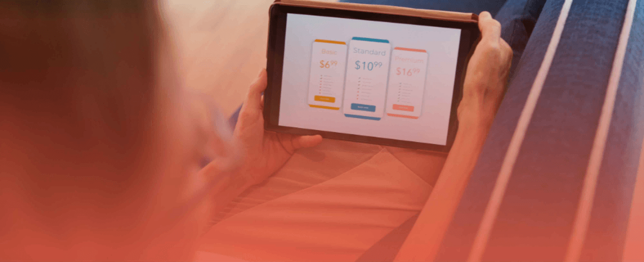 Person reviewing Pimcore Enterprise and Community Edition pricing options on a tablet, highlighting enterprise features and business value
