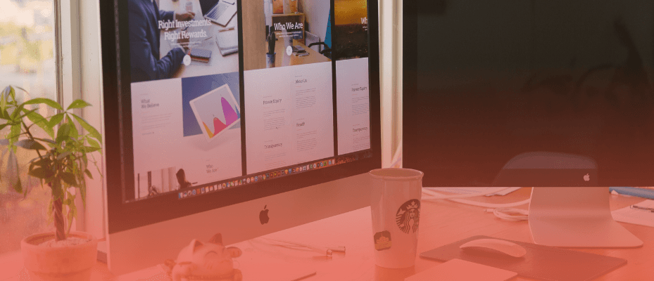 Modern workspace with Apple iMac computers displaying a website editing interface, illustrating a visual content editing experience similar to Storyblok Visual Editor