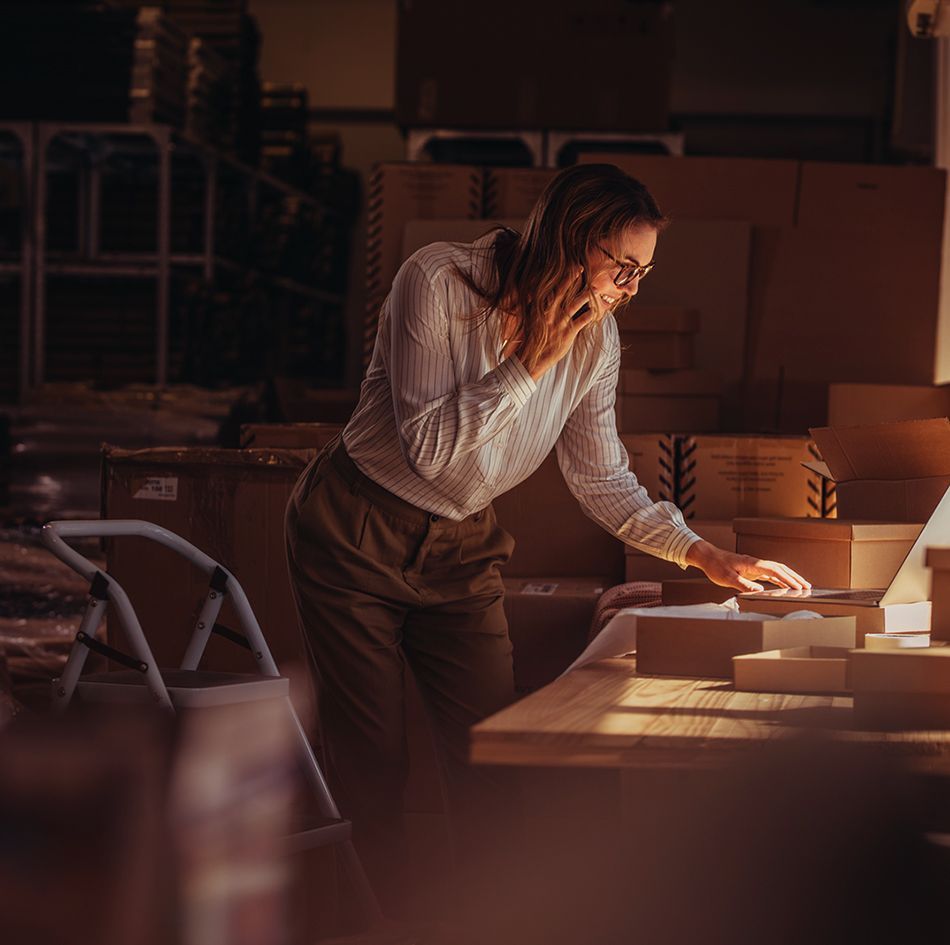 Woman multitasking with laptop and phone_image