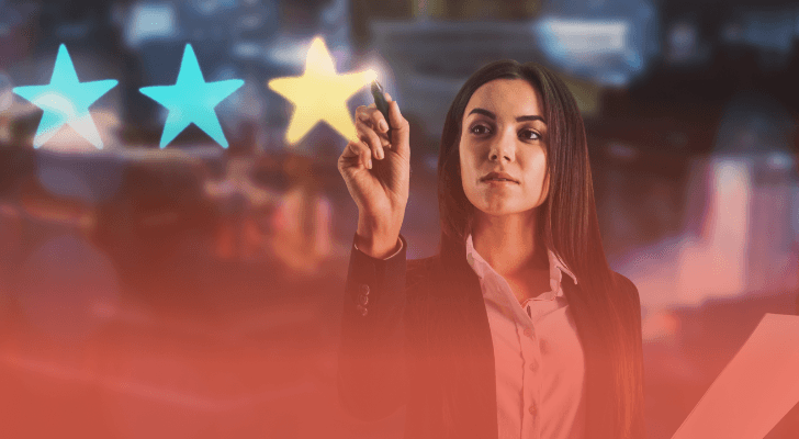 Businesswoman selecting a five-star rating for top PIM implementation companies in 2026