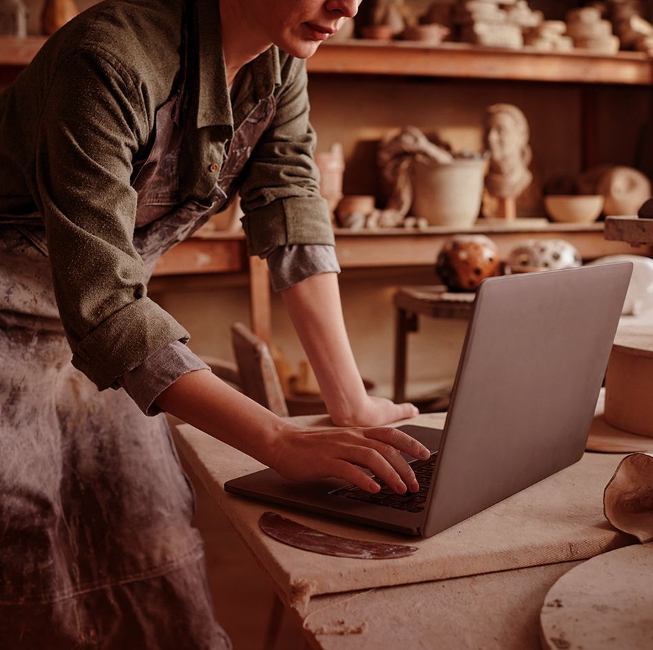 Woman using laptop running a craft business_image