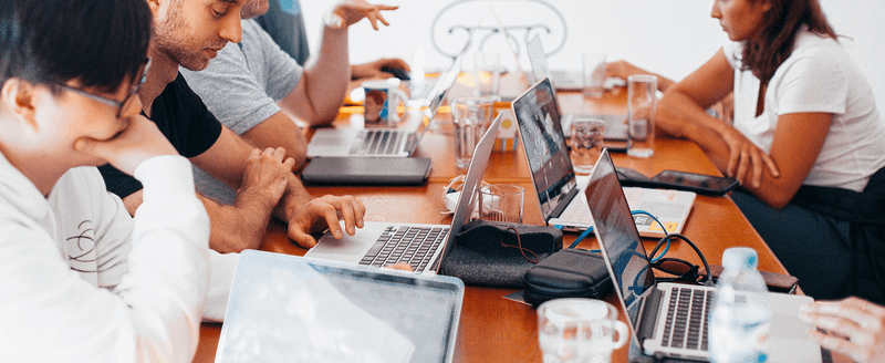 People with laptops in a coworking space_image