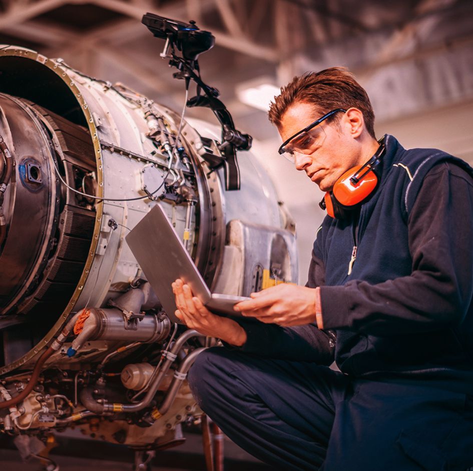 Male factory worker using digital tablet while standing in manufacturing industry_image