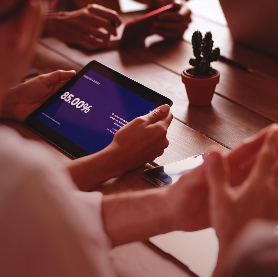 Cropped hands of team members using tablet computer and laptop in meeting_image