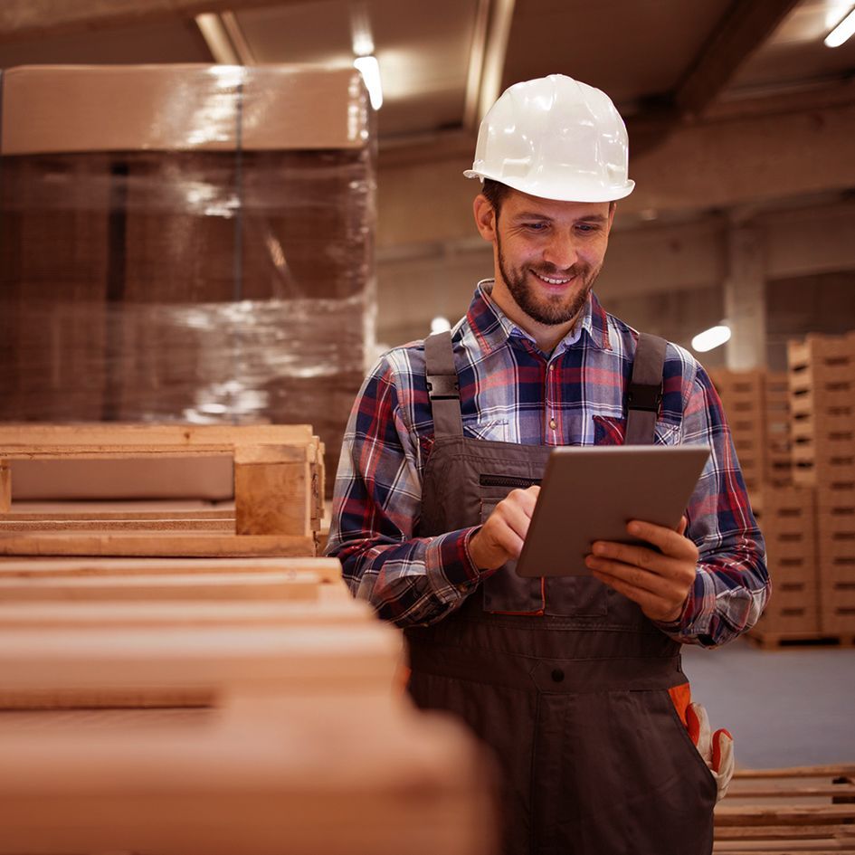 Mobile manufacturing, manufacturer working on a tablet_image