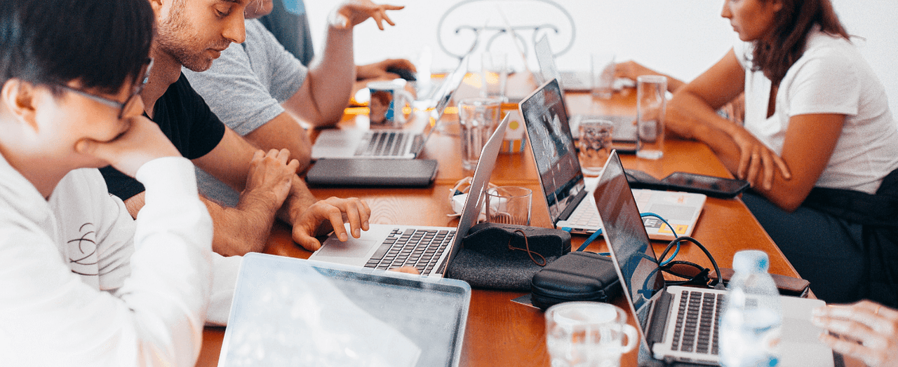 People with laptops in a coworking space_image