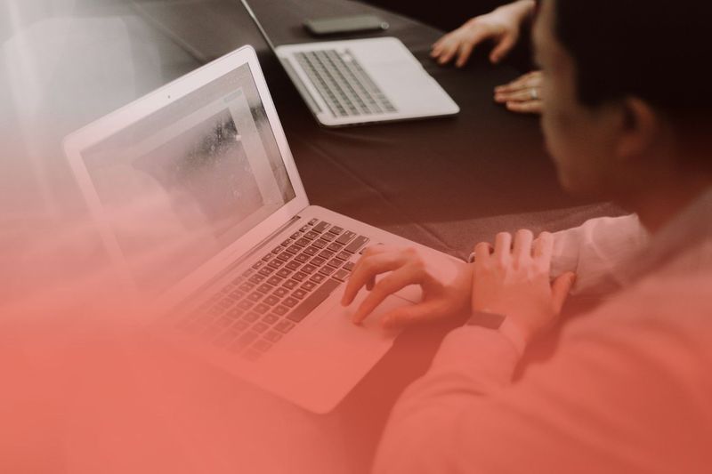 Developer using a laptop to build AI-powered applications with Headless AI architecture and API-first technologies