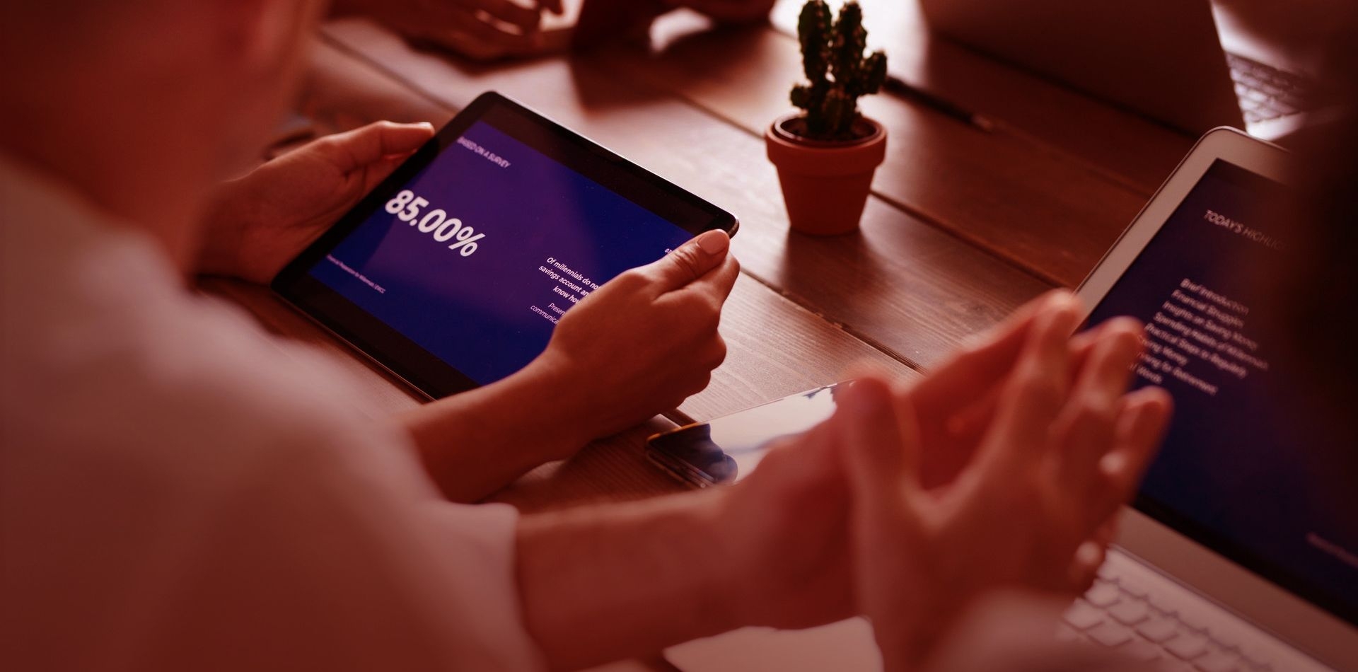 Cropped hands of team members using tablet computer and laptop in meeting_image