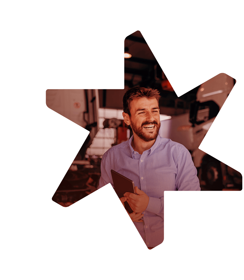 Smiling man using tablet at work