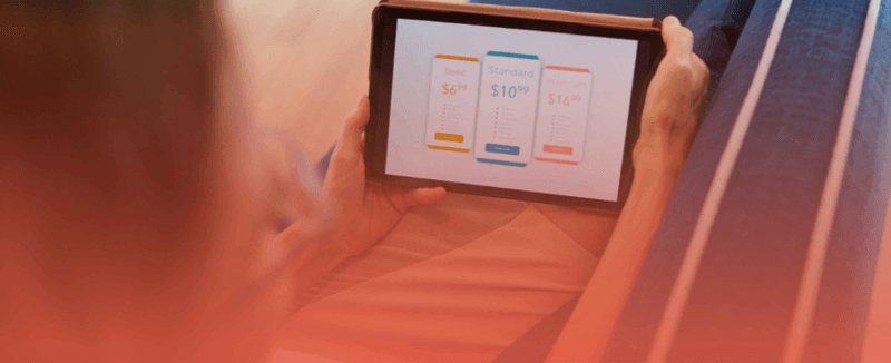 Person reviewing Pimcore Enterprise and Community Edition pricing options on a tablet, highlighting enterprise features and business value